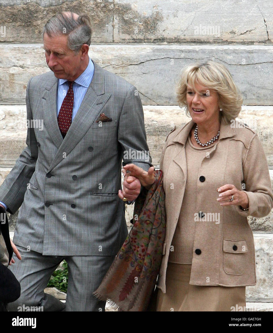 The Prince of Wales and the Duchess of Cornwall holding hands whilst visiting the ruined library of Celsus in Ephesus, Turkey. Stock Photo
