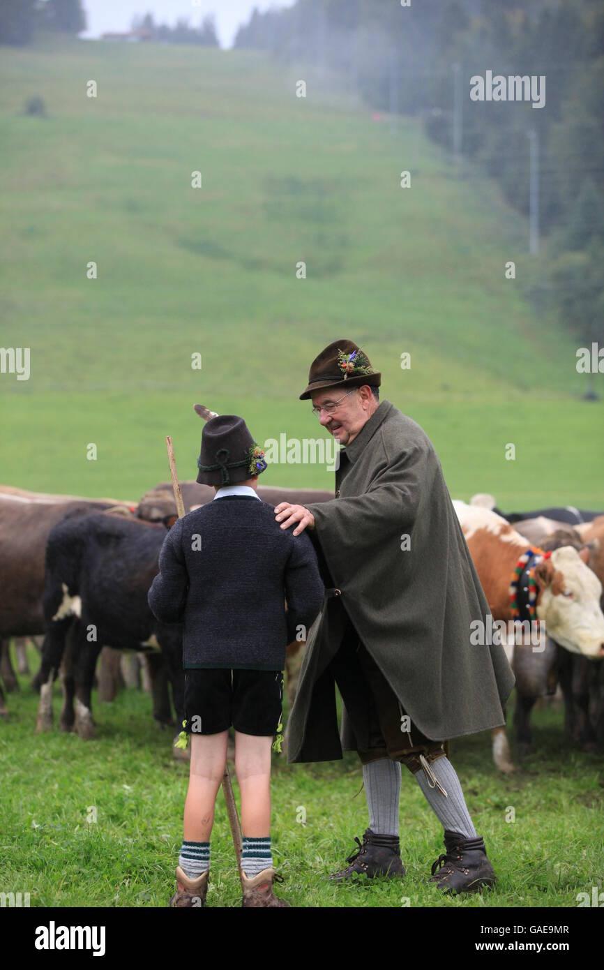 Boy and man wearing traditional costume during Viehscheid, Thalkirchdorf, Oberstaufen, Bavaria Stock Photo