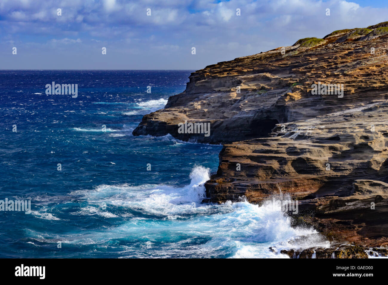 Ocean Waves Crashing against rocks and cliffs. Splashing, foamy water course textured rocks Stock Photo
