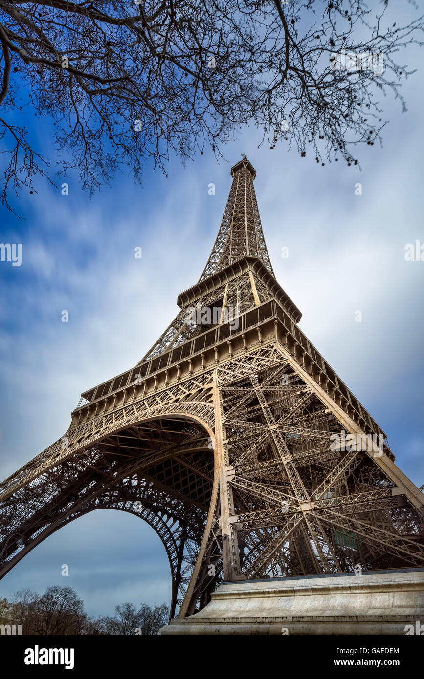 Low angle view Eiffel Tower and passing clouds, Paris, France Stock Photo
