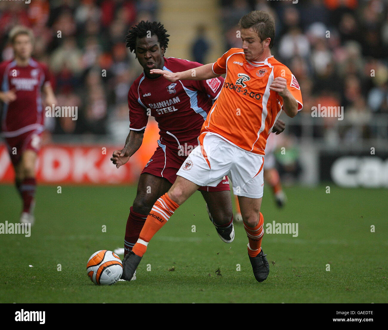Blackpool's Keigan Parker and Scuntorpe United's Kelly Youga during the Coca-Cola Football League Championship match at Bloomfield Road, Blackpool. Stock Photo
