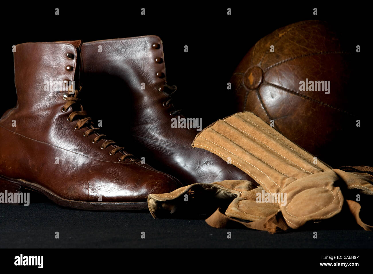 Early boots and shinpads worn for football on show at the National Football Museum, Preston Stock Photo