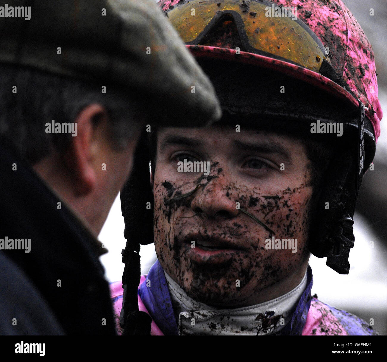 Jockey Sam Thomas talks to trainer Paul Nicholls after riding Robin de Sherwood in the Browne's Gazette Intermediate Handicap Hurdle at Cheltenham Racecourse. Stock Photo