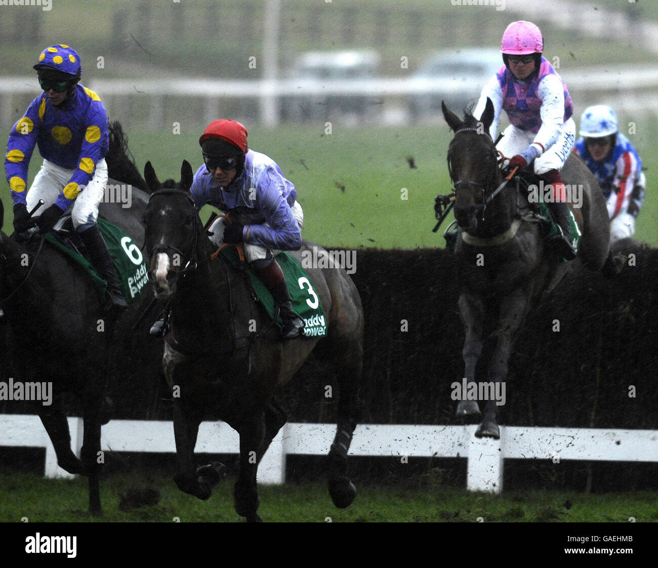 Kalca Mome ridden by Richard Johnson (centre) gets away from the second fence on their way to winning the Paddypower.com Handicap Chase at Cheltenham Racecourse. Stock Photo