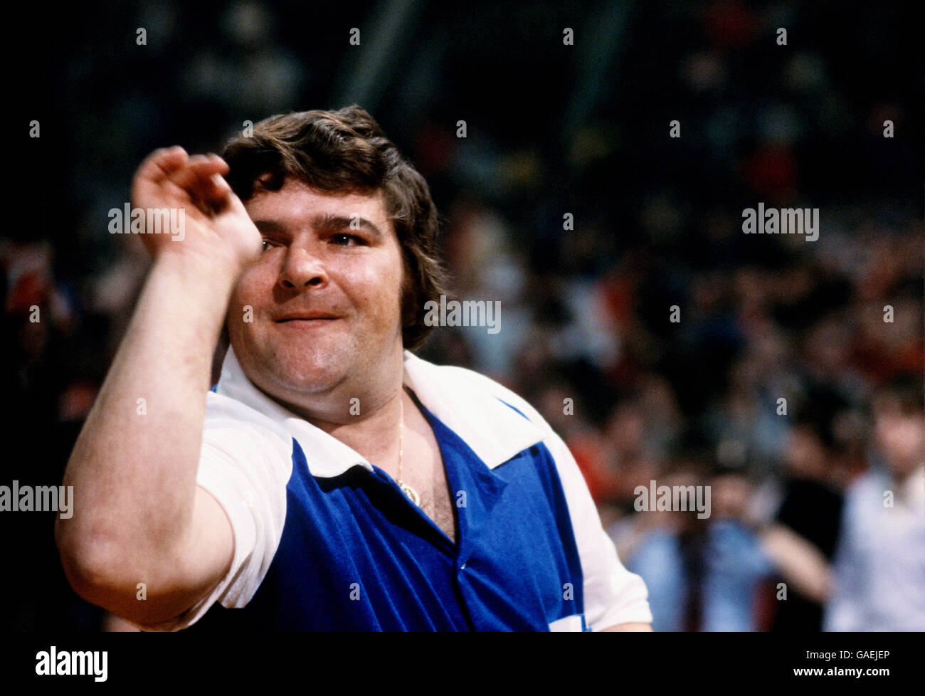 British professional darts player Jocky Wilson holding a tea cup and