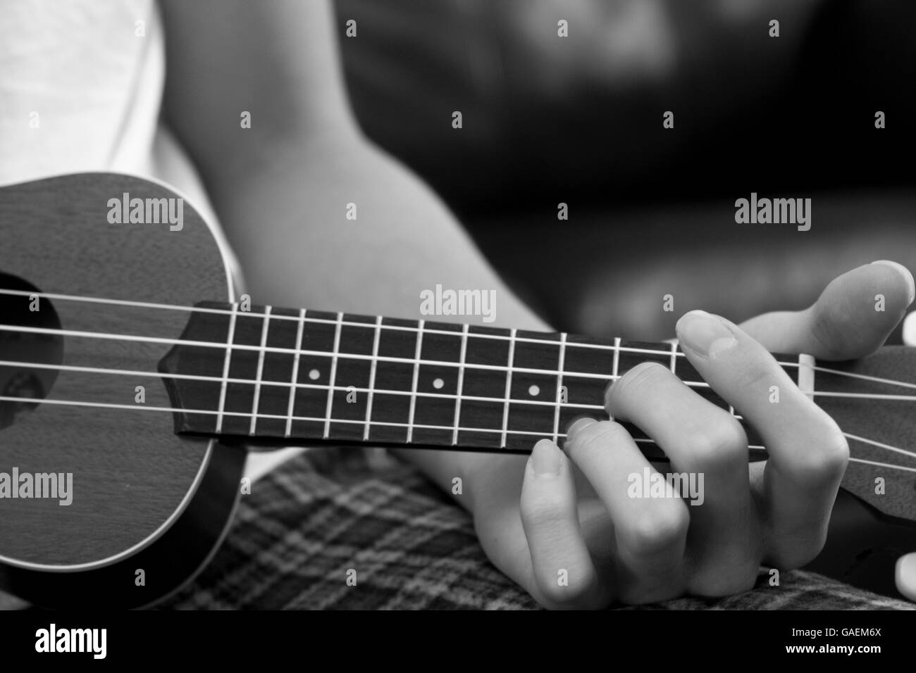 Boy playing the ukulele Stock Photo Alamy
