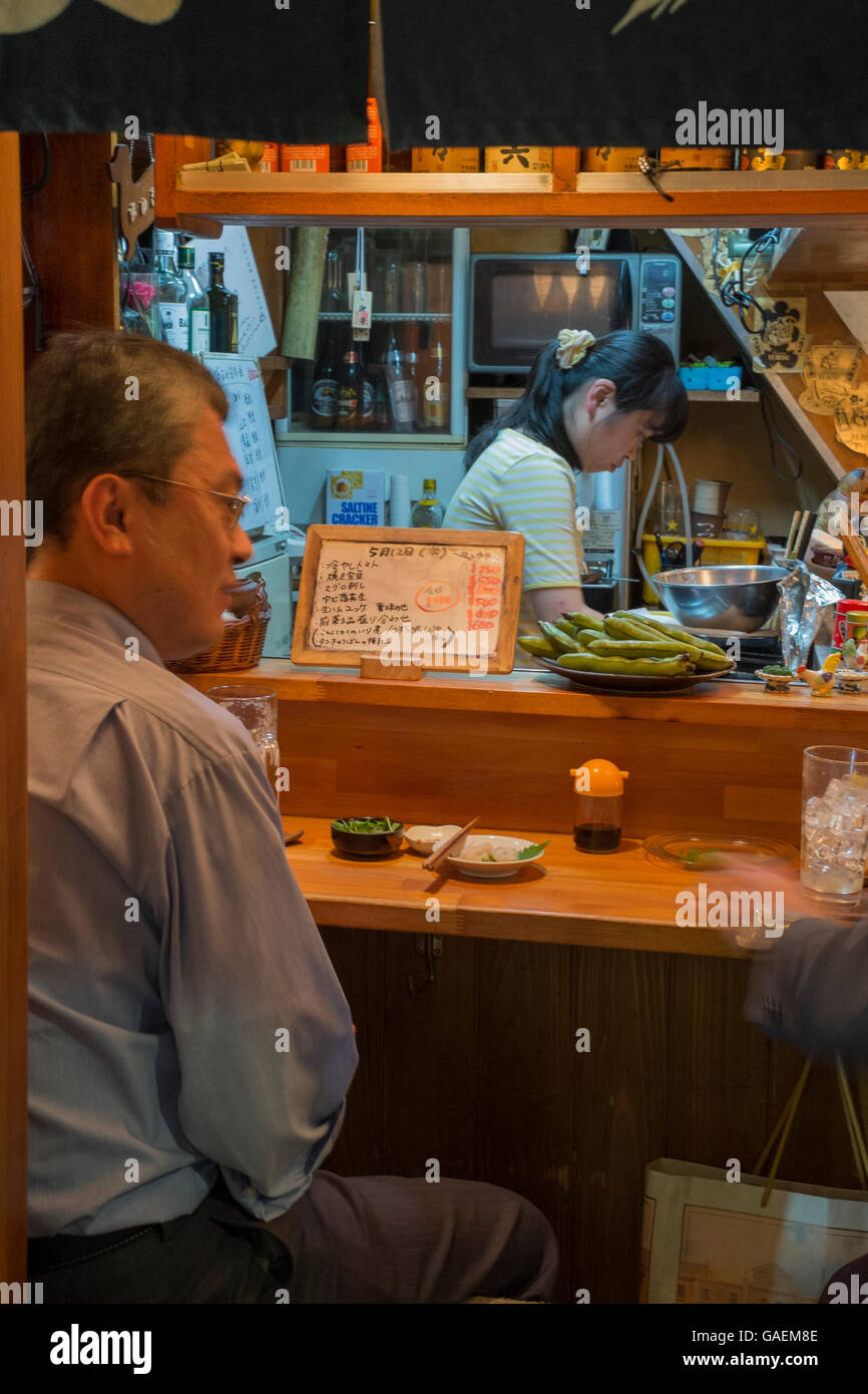 A Japanese man having dinner in a restaurant in Japan. Stock Photo