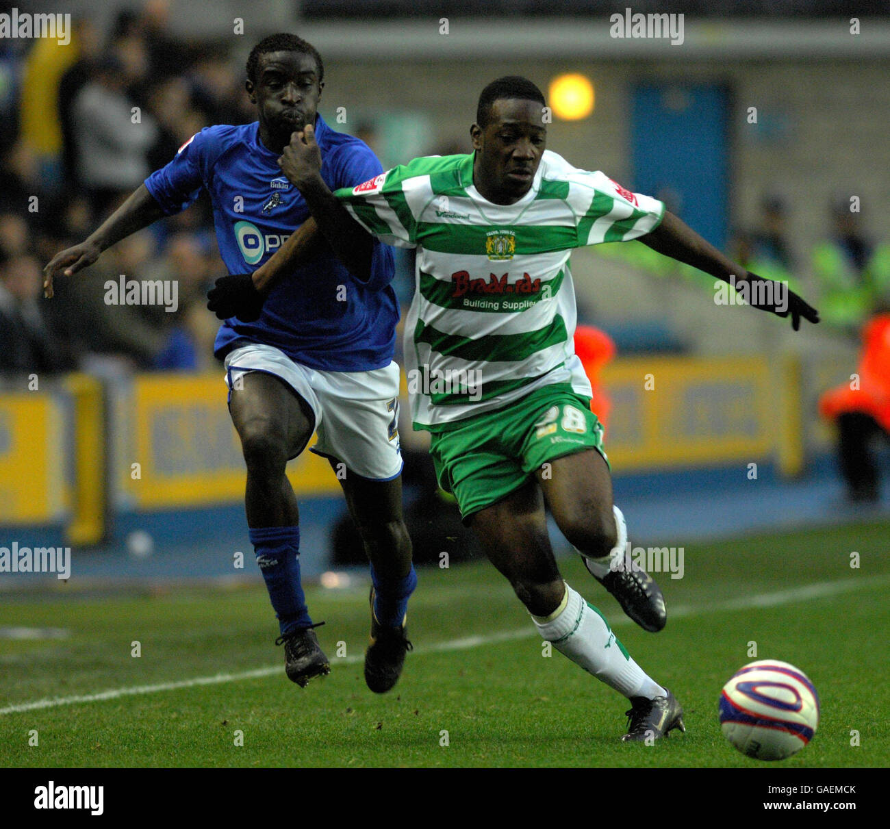 Millwall's Zoumana Bakayogo and Yeovil Town's James Walker during the Coca-Cola Football League One match at The New Den, London. Stock Photo