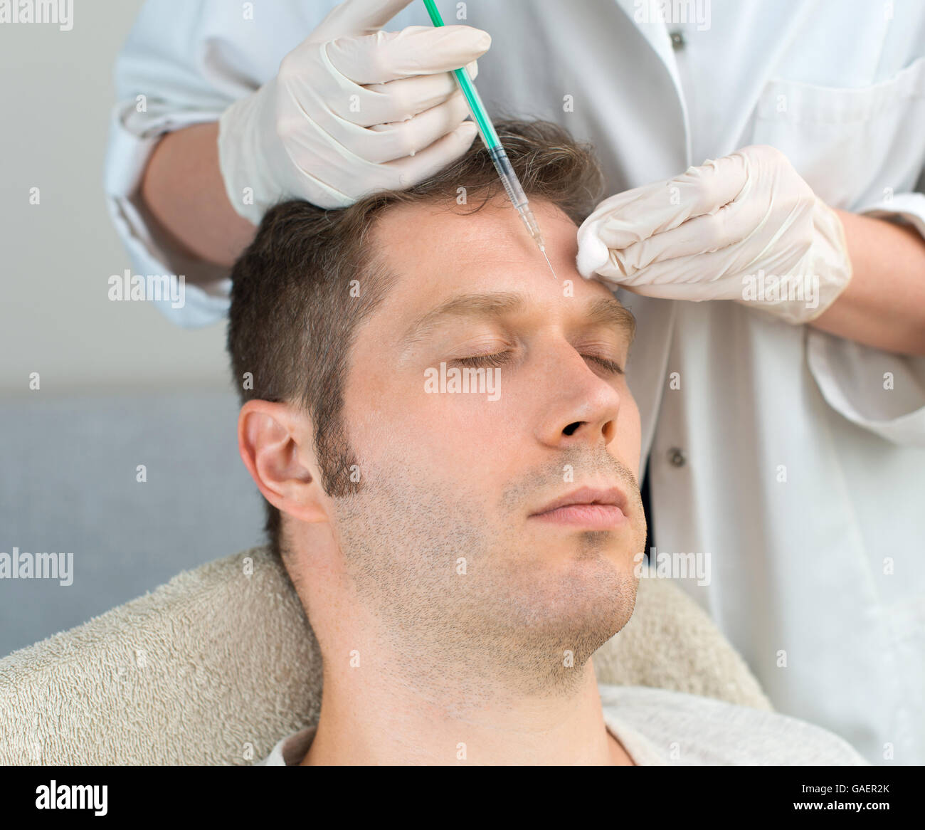 Handsome man is getting injection. Concept of aesthetic beauty. Stock Photo