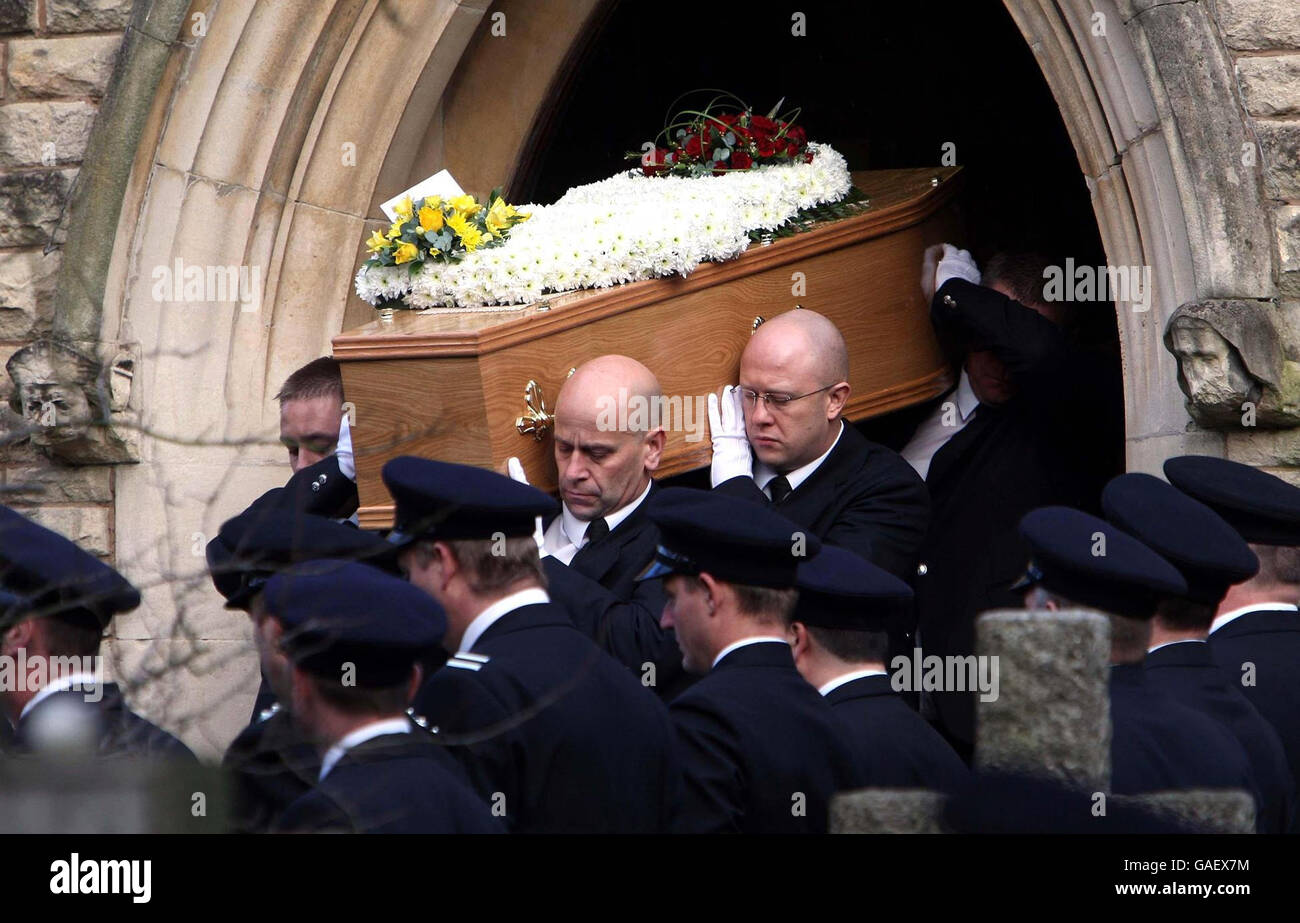The coffin of Ian Reid is carried from St Gregory the Great Catholic
