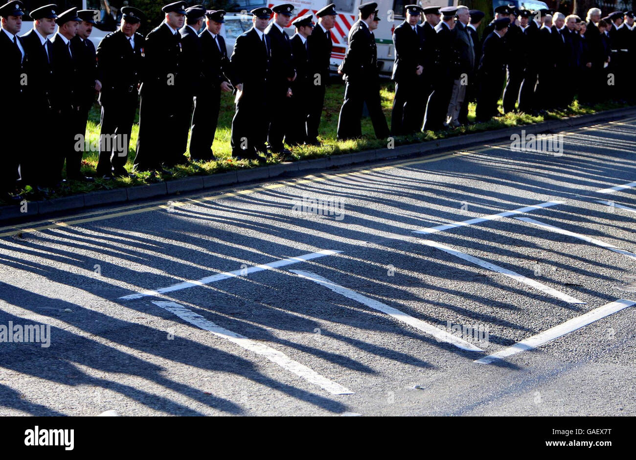 Firefighters line the streets waiting for the coffin of Ian Reid to arrive at St Gregory the