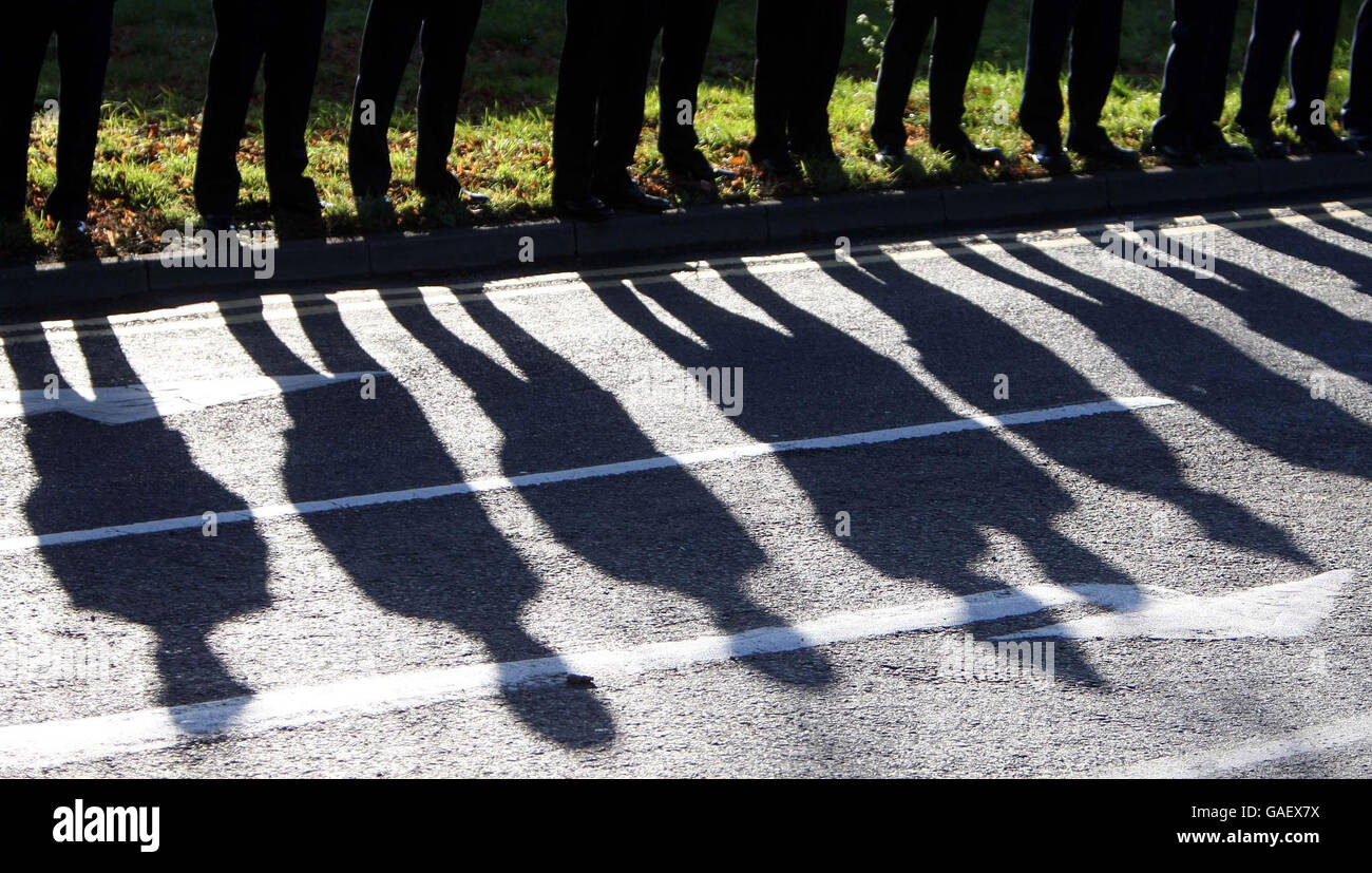 Firefighters line the streets waiting for the coffin of Ian Reid to arrive at St Gregory the