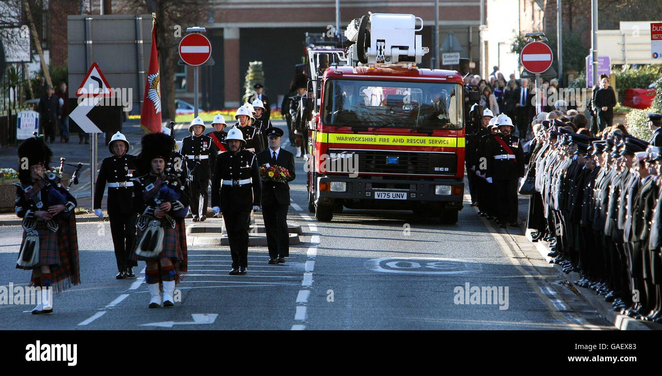 The fire appliance carrying the coffin of Ian Reid arrives at St