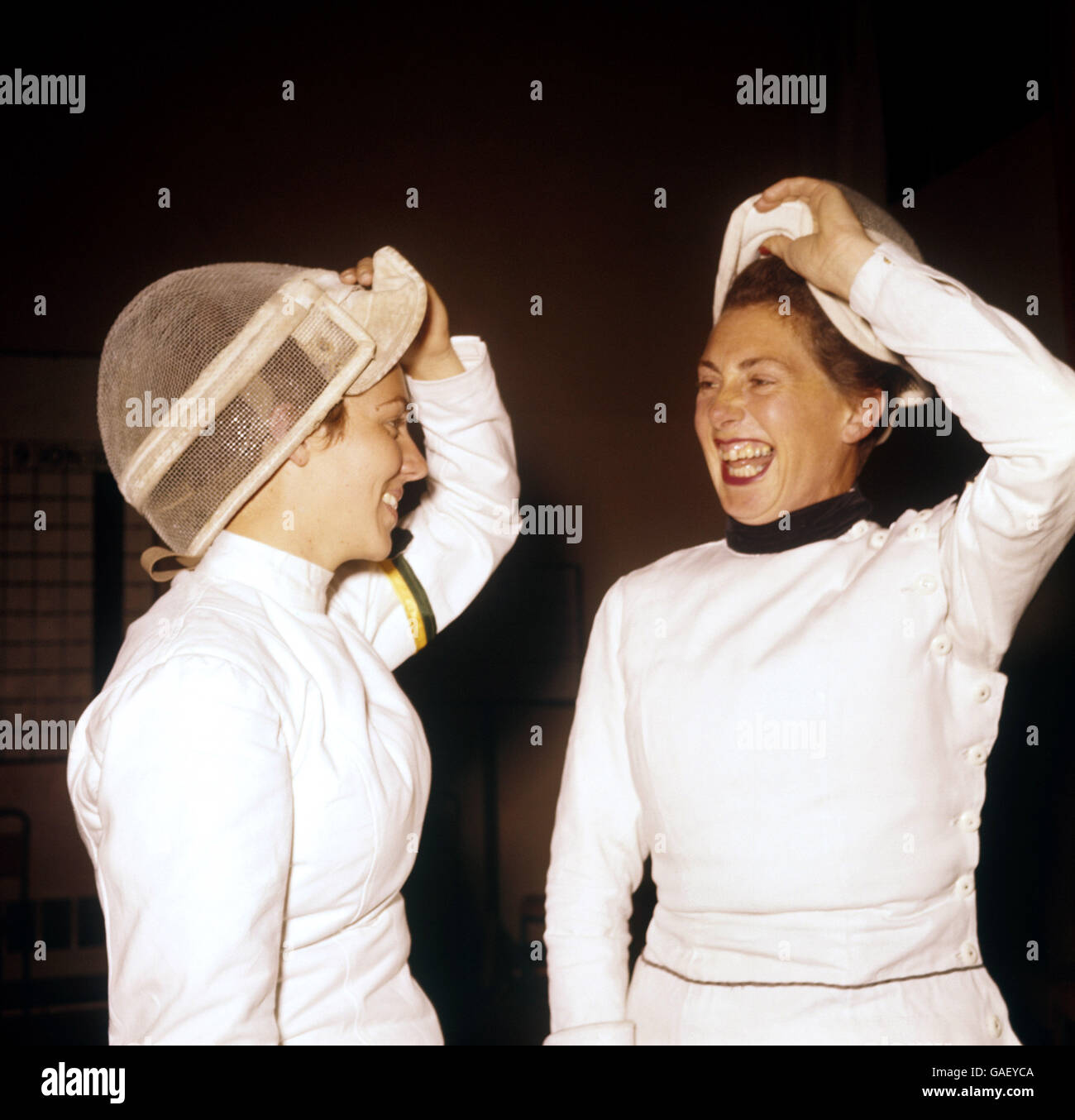 1958 British Empire and Commonwealth Games - Fencing - Cardiff. New Zealand's Mrs FE McElwee (r) and Australia's Miss Barbara McGreath after their bout in the women's fencing Stock Photo