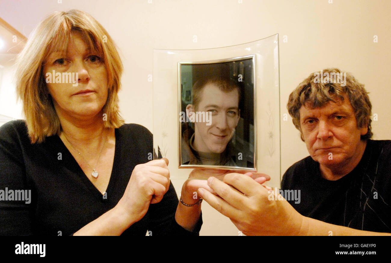 Trish and Graham Knight at their home in Bridgwater, Somerset, hold a photograph of their son Ben Knight. Ben was killed in an RAF Nimrod crash last year, an MoD report into the crash was released today. Stock Photo