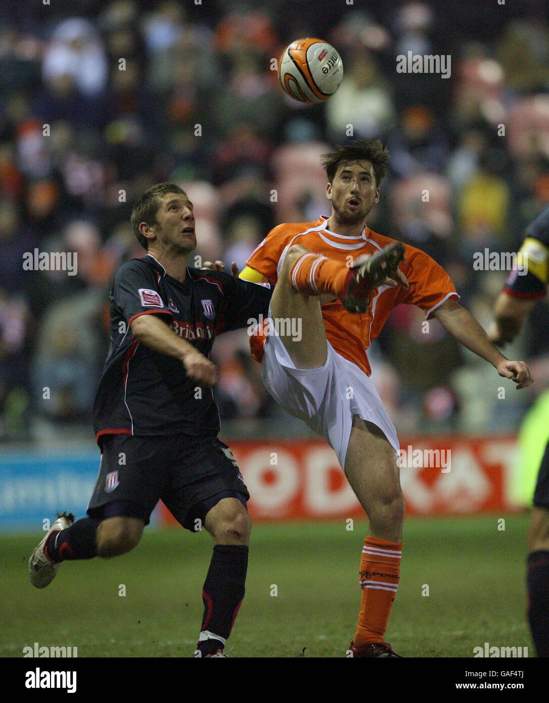 Stoke City's Leon Cort (left) goes in for the ball during the Coca-Cola Championship match at Bloomfield Road, Blackpool. Stock Photo