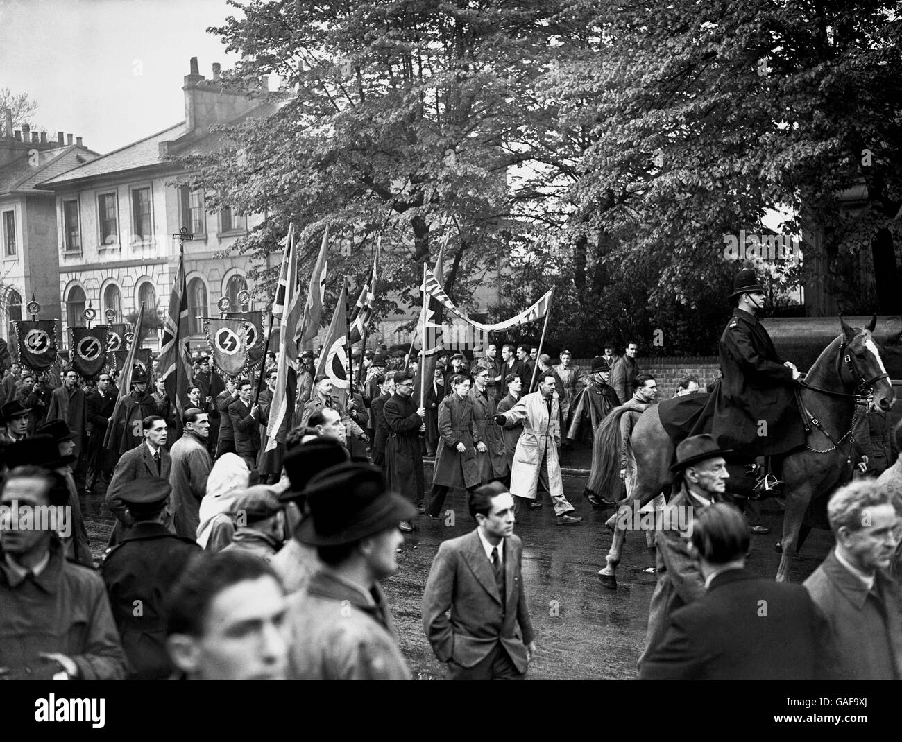 Sir Oswald Mosley supporters holding an open air May Day meeting. Police mingled with the crowds who formed to hear speakers, surrounded by Union Movement members carrying the movement's banner the white lightning flash on a red background. The Union Movement was recently founded by Mosley and several ex -members of the British Union of Fascists and has a more Pan-European outlook as it seeks to bring about a European Super-power to balance the threat from the USSR and the USA. Stock Photo
