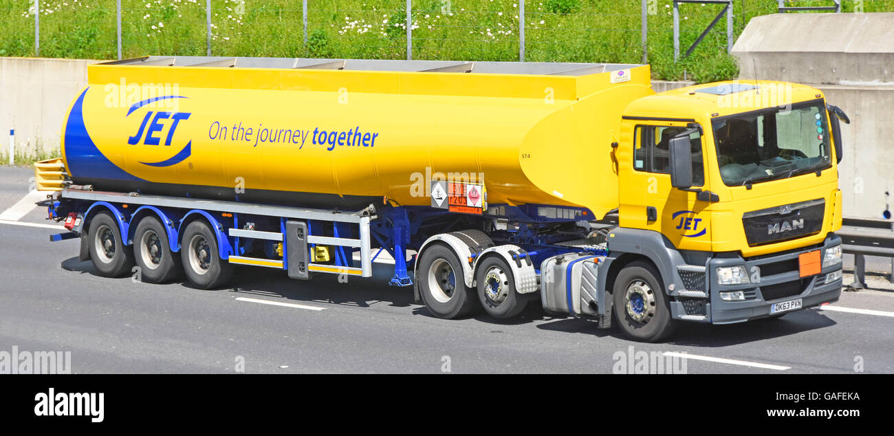 Jet fuel tanker supply chain transportation logistics lorry drives along UK motorway shows Hazchem Hazardous Chemicals Dangerous Goods sign on trailer Stock Photo