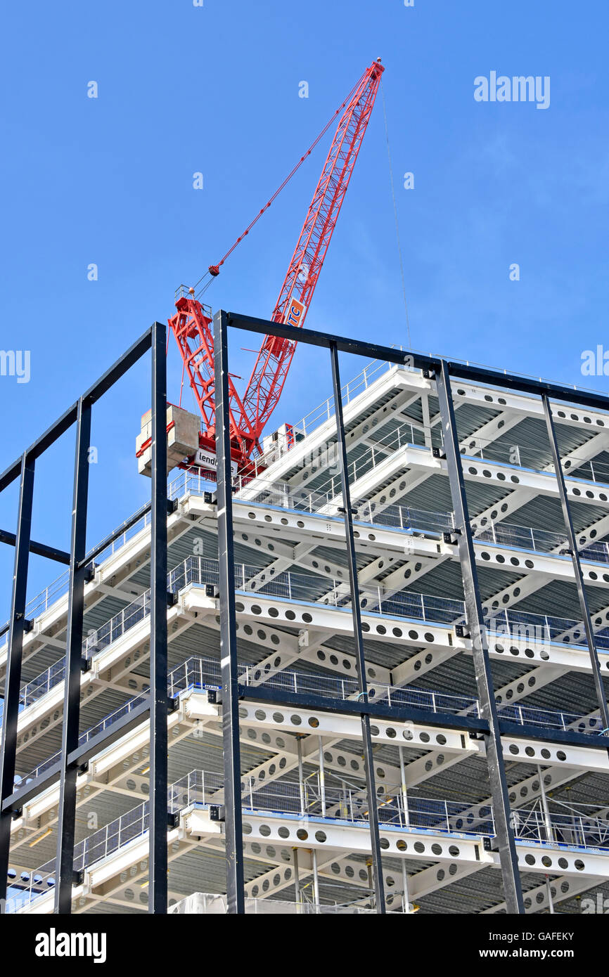 Crane on building construction site  steel framed building with preformed holes in beams facilitate installation of services Croydon London England UK Stock Photo