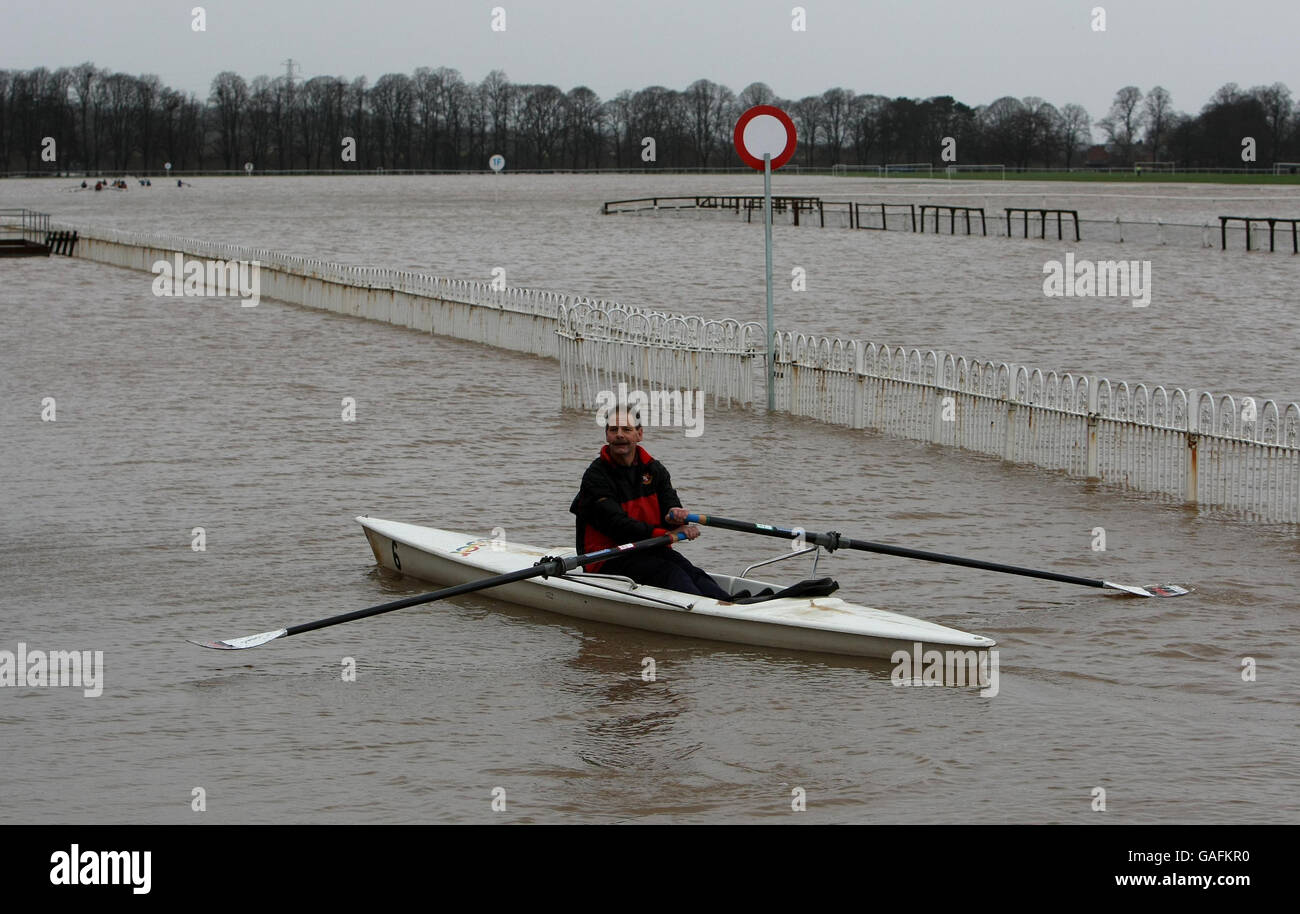 A Worcester rowing club member sculls along the finishing straight at a flooded Worcester