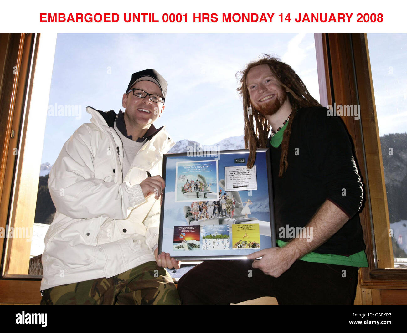 Singer-songwriter Newton Faulkner (right) is presented with a platinim gold disc by Virgin Radio DJ Ben Jones (marking half a million sales of his album 'Hand Built by Robots'), after performing a Virgin Radio session gig in a hot air balloon thousands of feet above the Swiss Alps, near Gruyere, Switzerland. Stock Photo