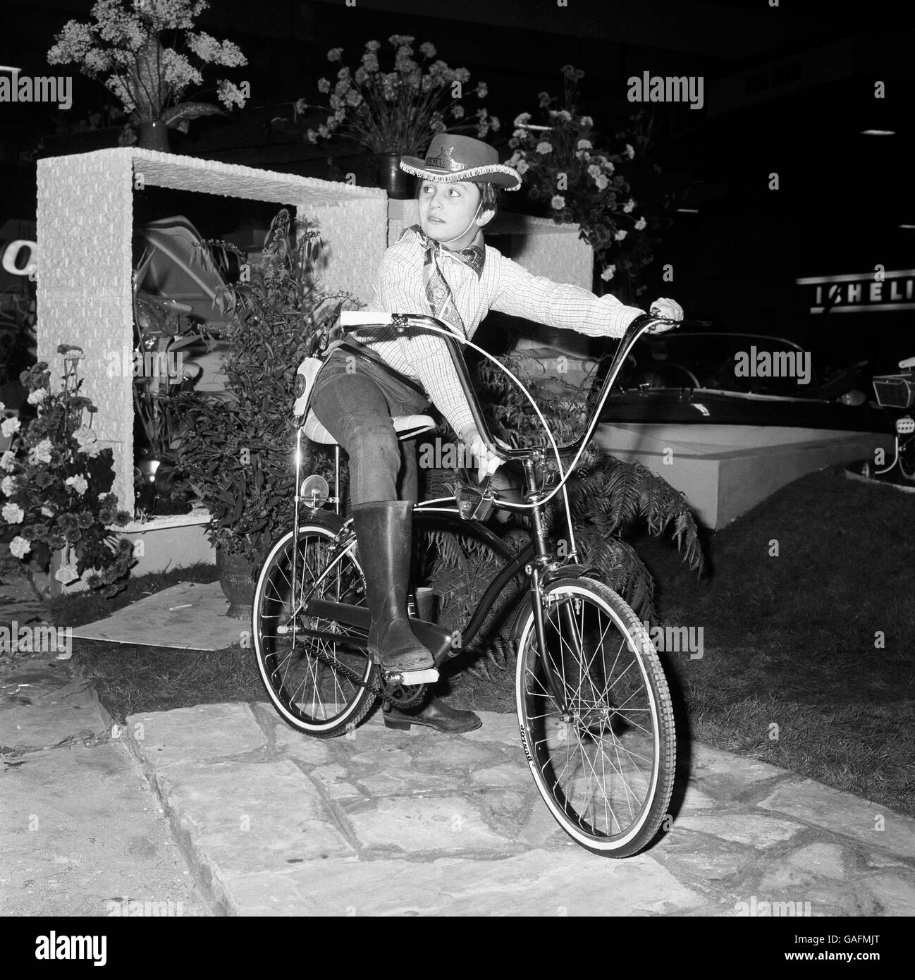 Dressed for some American style cycling is 12 year old Robert Roylance of London, seen mounted on the Raleigh 'Mustang' bicycle at the International Cycle and Motor Show at Earls Court. Stock Photo