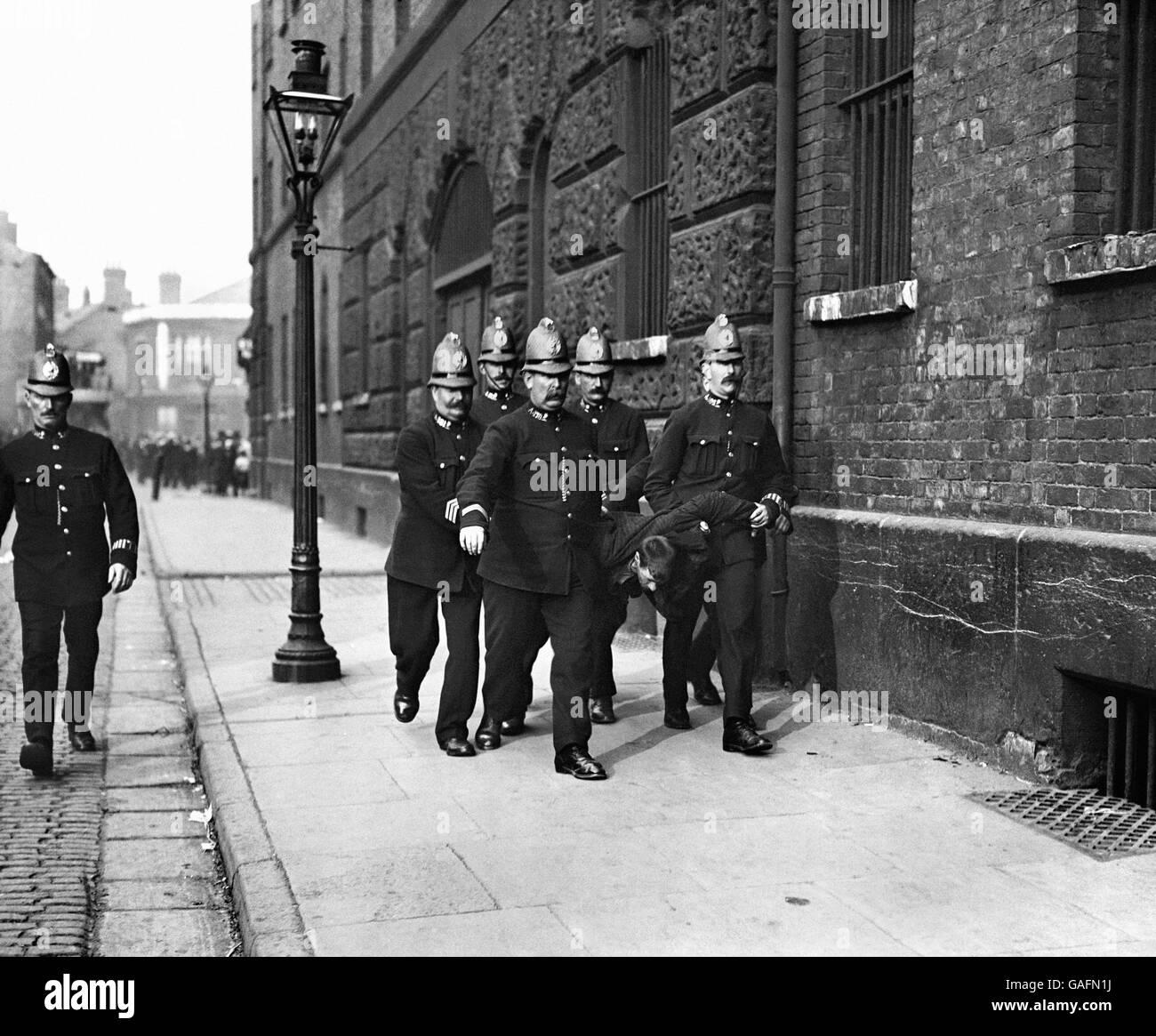 Crime, Police and Prisoner. Police frog marching a prisoner in Liverpool. Stock Photo
