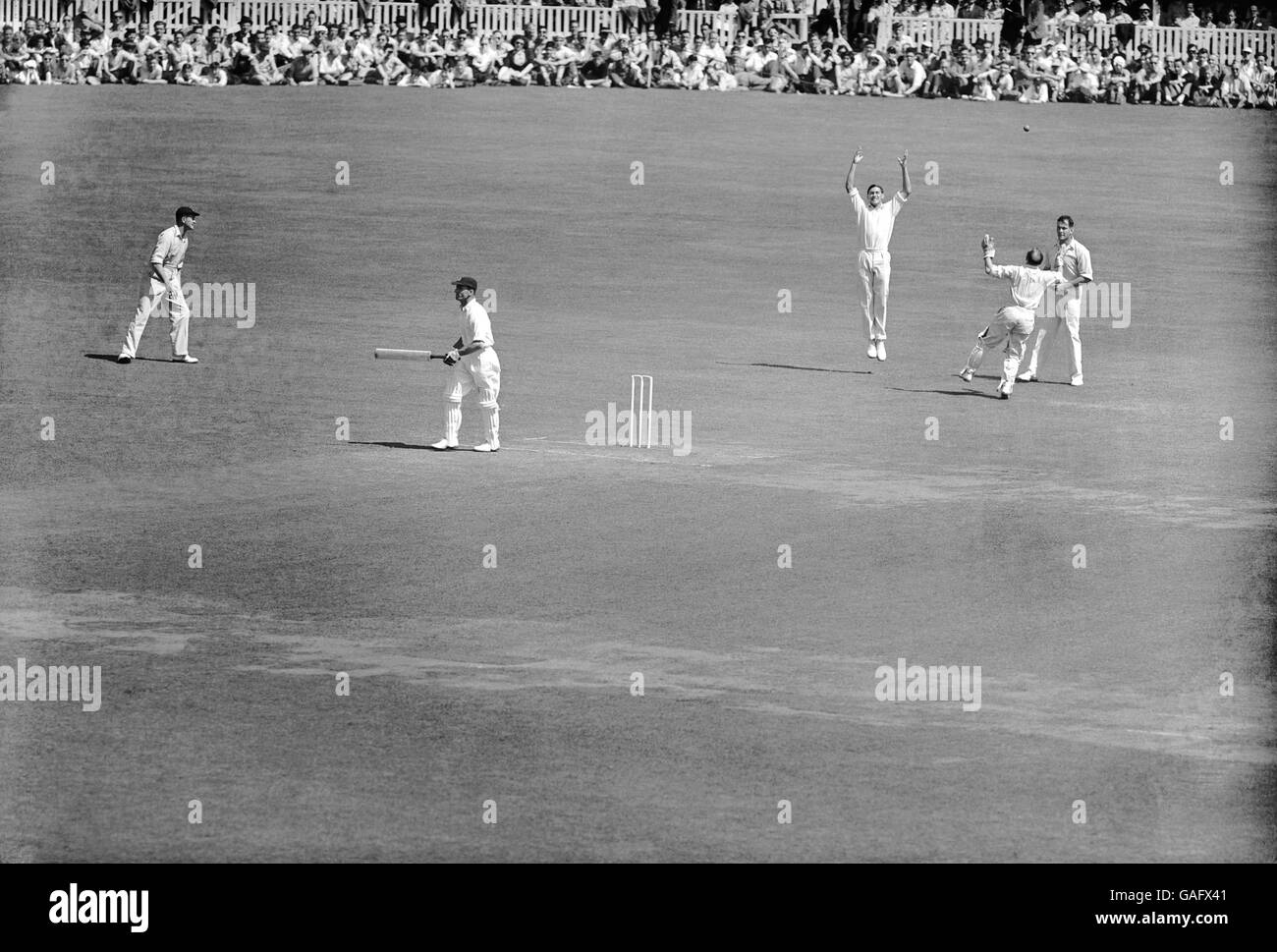 Middlesex's Jack Robertson (second l) walks off after being caught behind by celebrating Surrey wicketkeeper Arthur McIntyre (second r) off the bowling of Peter Loader (out of picture) for 14 Stock Photo