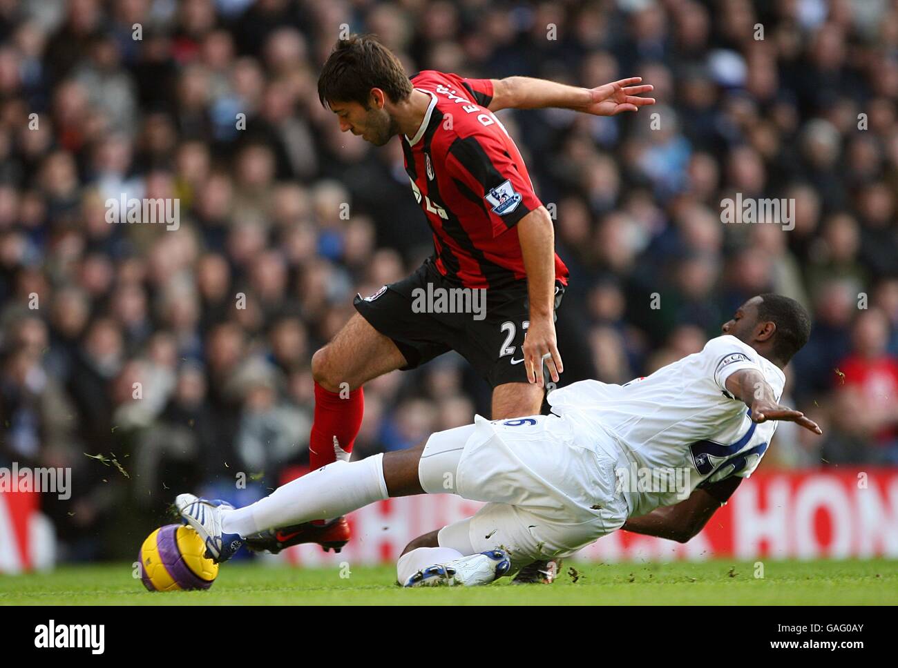 Tottenham Hotspur's Ledley King (right) slides in with a challenge on ...