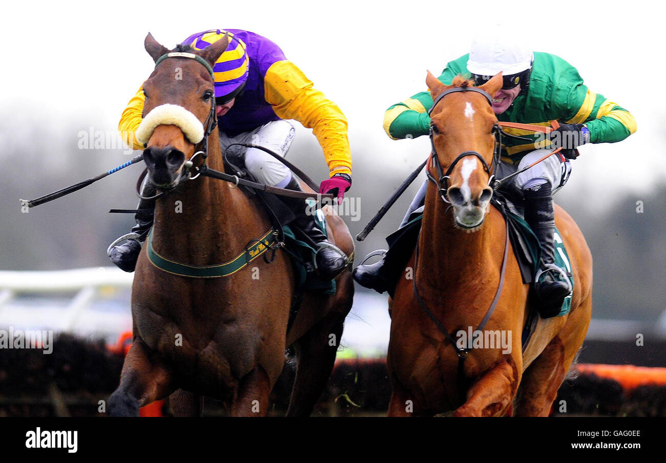 Tony McCoy on Straw Bear (right) jumps the last ahead of Harchibald and Paul Carberrry to win The Stan James Christmas Hurdle at Kempton Park Racecourse. Stock Photo
