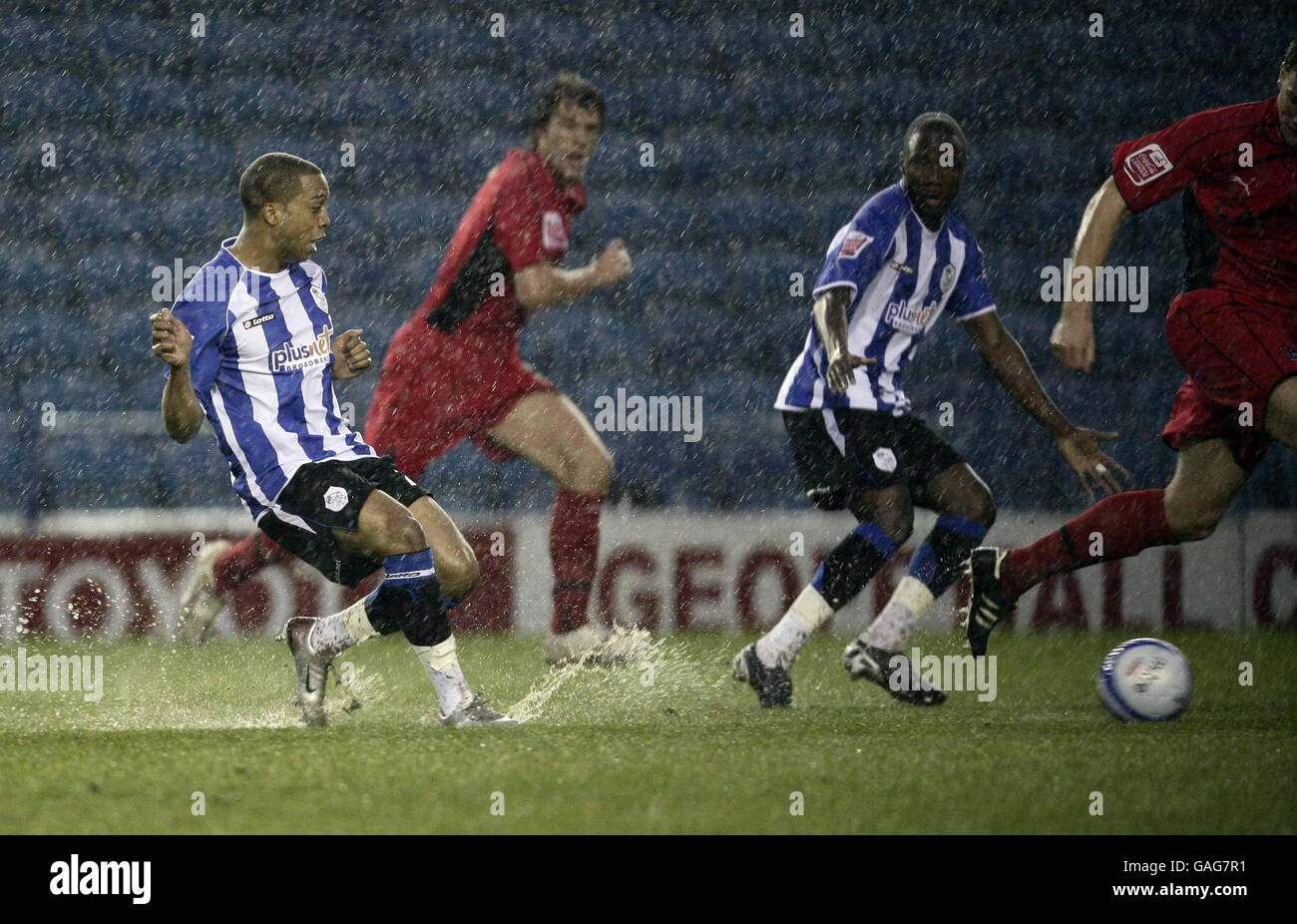 Sheffield Wednesday's Wade Small tries to pass on the soaked pitch during the Coca-Cola League Championship match at Hillsborough, Sheffield. Stock Photo