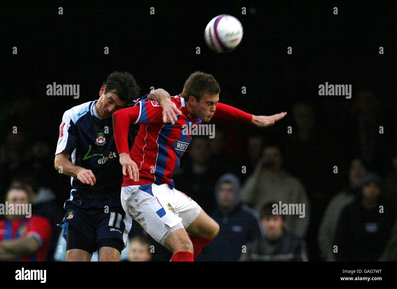 Dagenhams' Shane Huke and Wrexhams' Chris Llewellyn fight for the ball during the Coca-Cola League Two match at Victoria Ground, Dagenham. Stock Photo