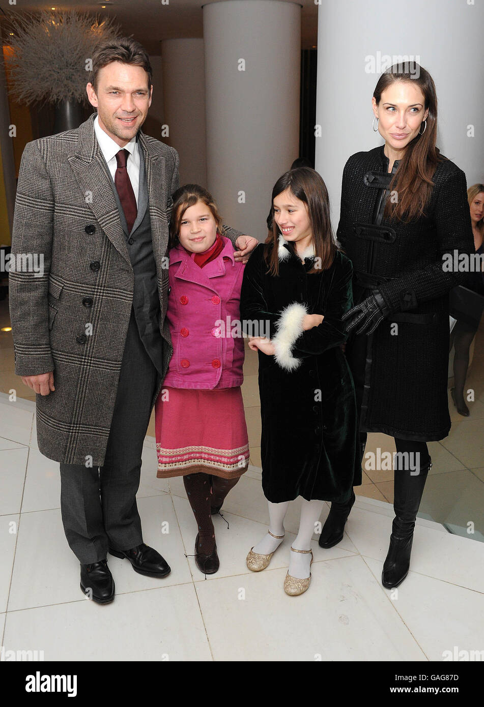 Actor Dougray Scott and wife, actress Claire Forlani with Scott's daughter Eden (2nd left) and her friend arrive for a VIP performance of Night of The Snow Queen to launch the English National Ballet's Christmas Season, at the Coliseum in London. Stock Photo