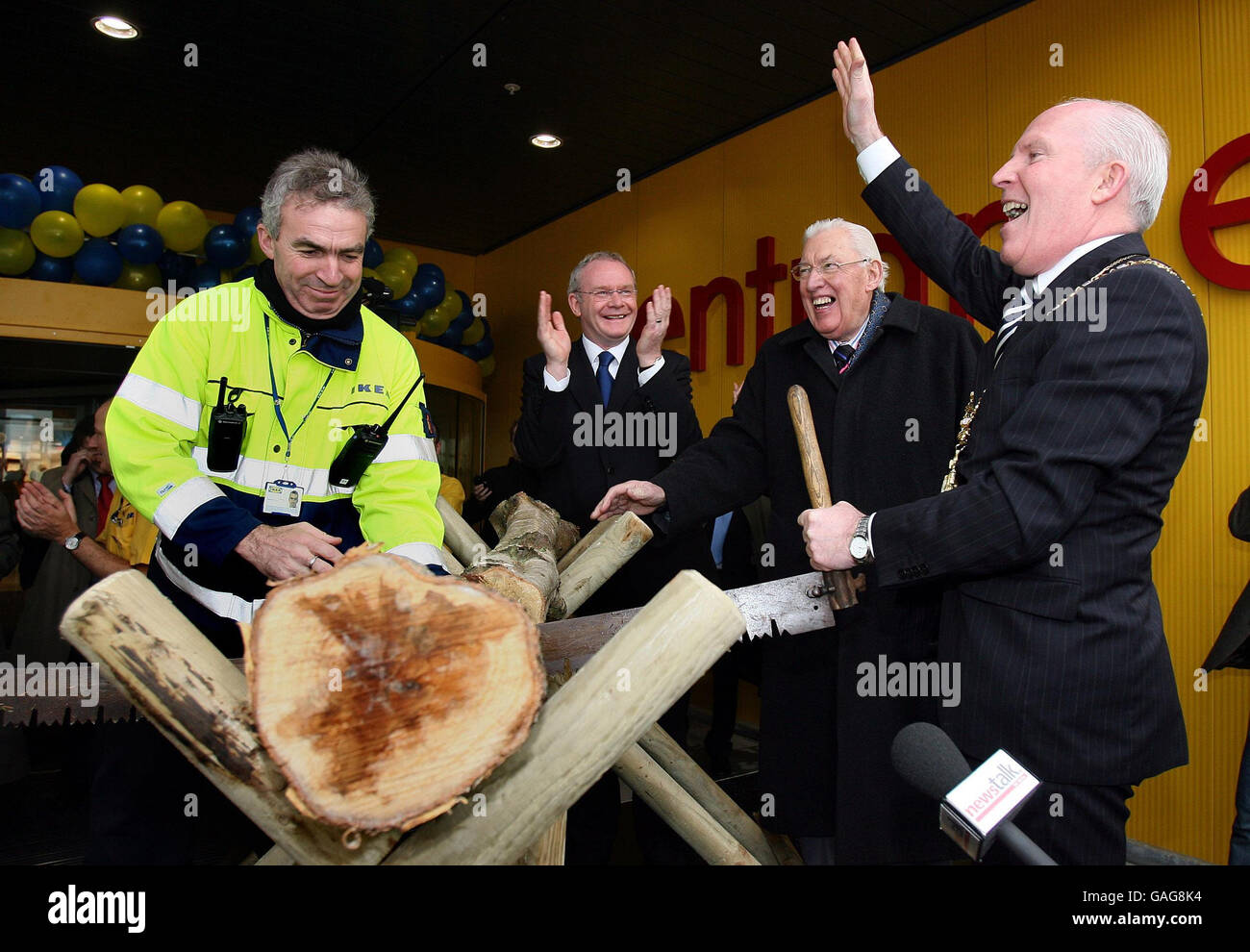 Belfast Lord Mayor Jim Rodgers (right) saws a log to officially open