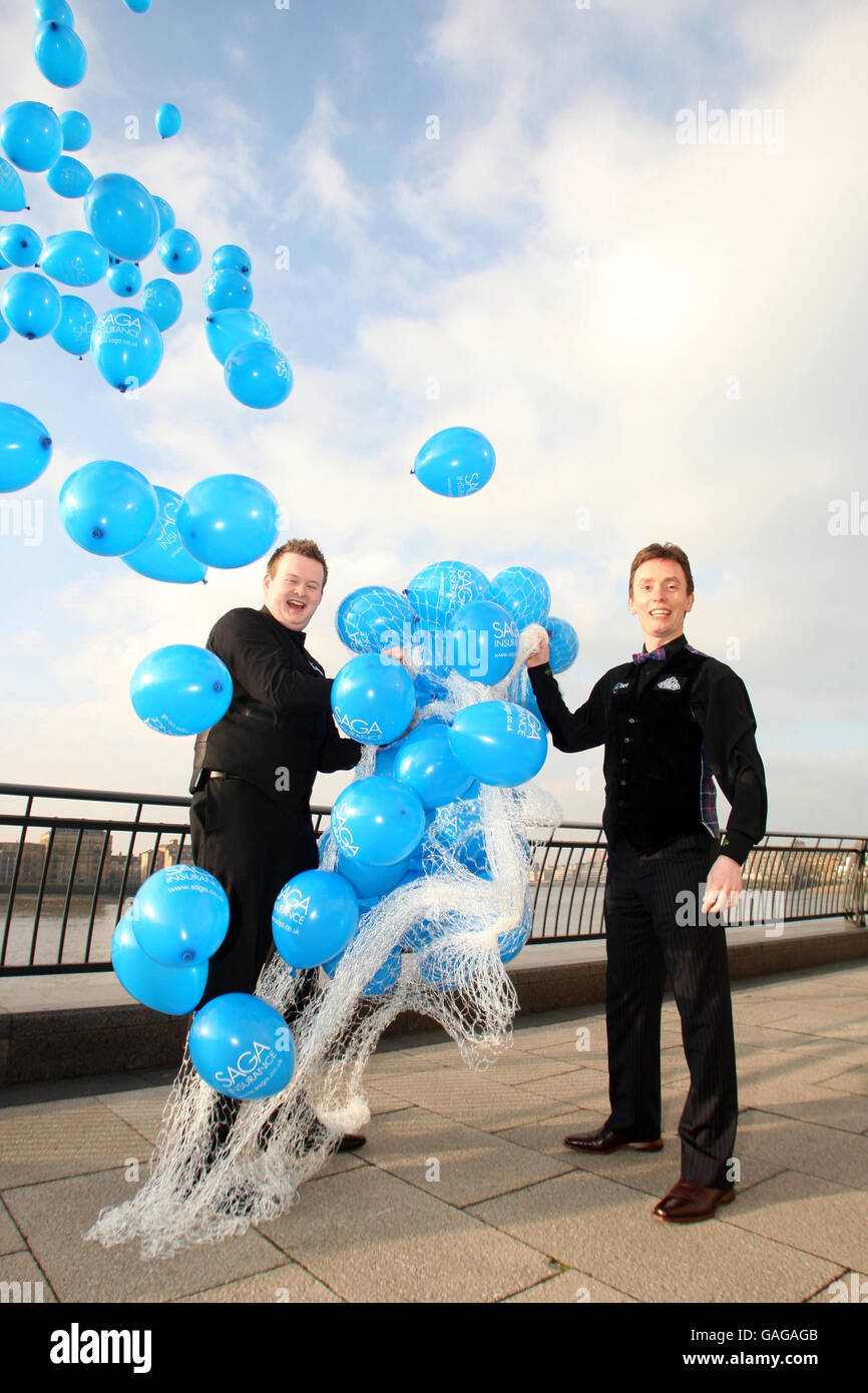 Snooker players Ken Doherty (right) and Shaun Murphy launch the SAGA Insurance Masters by releasing 200 balloons in Canary Wharf, London. Stock Photo