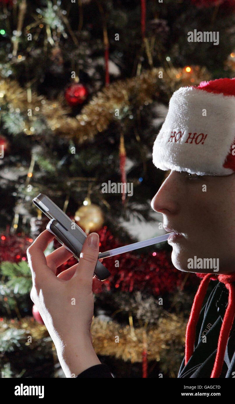 A person pictured using an Alcosense pocket Breathalyser, which can