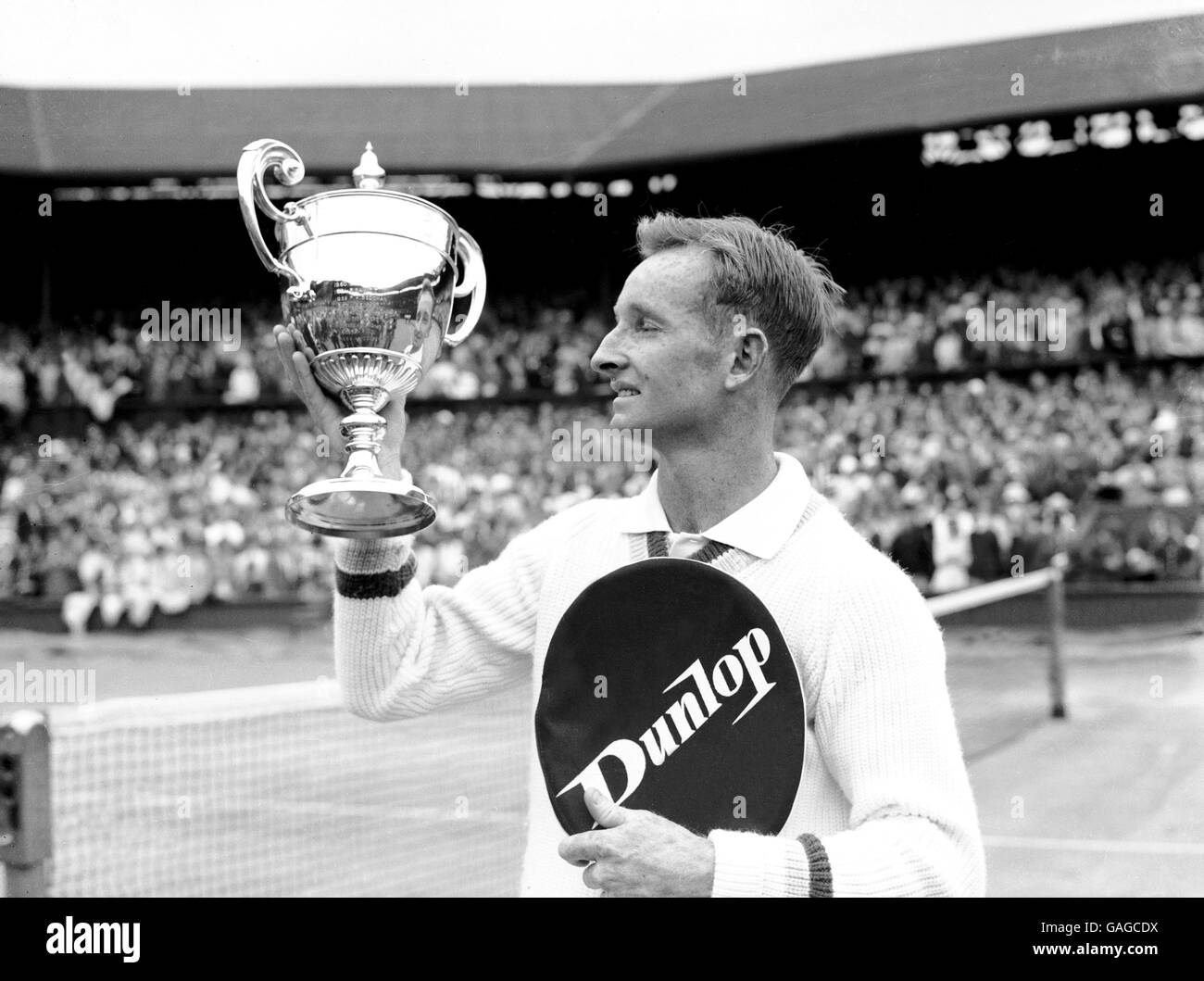 Rod Laver checks that his name has been engraved correctly on the Men's Singles trophy after winning it for the second consecutive year Stock Photo