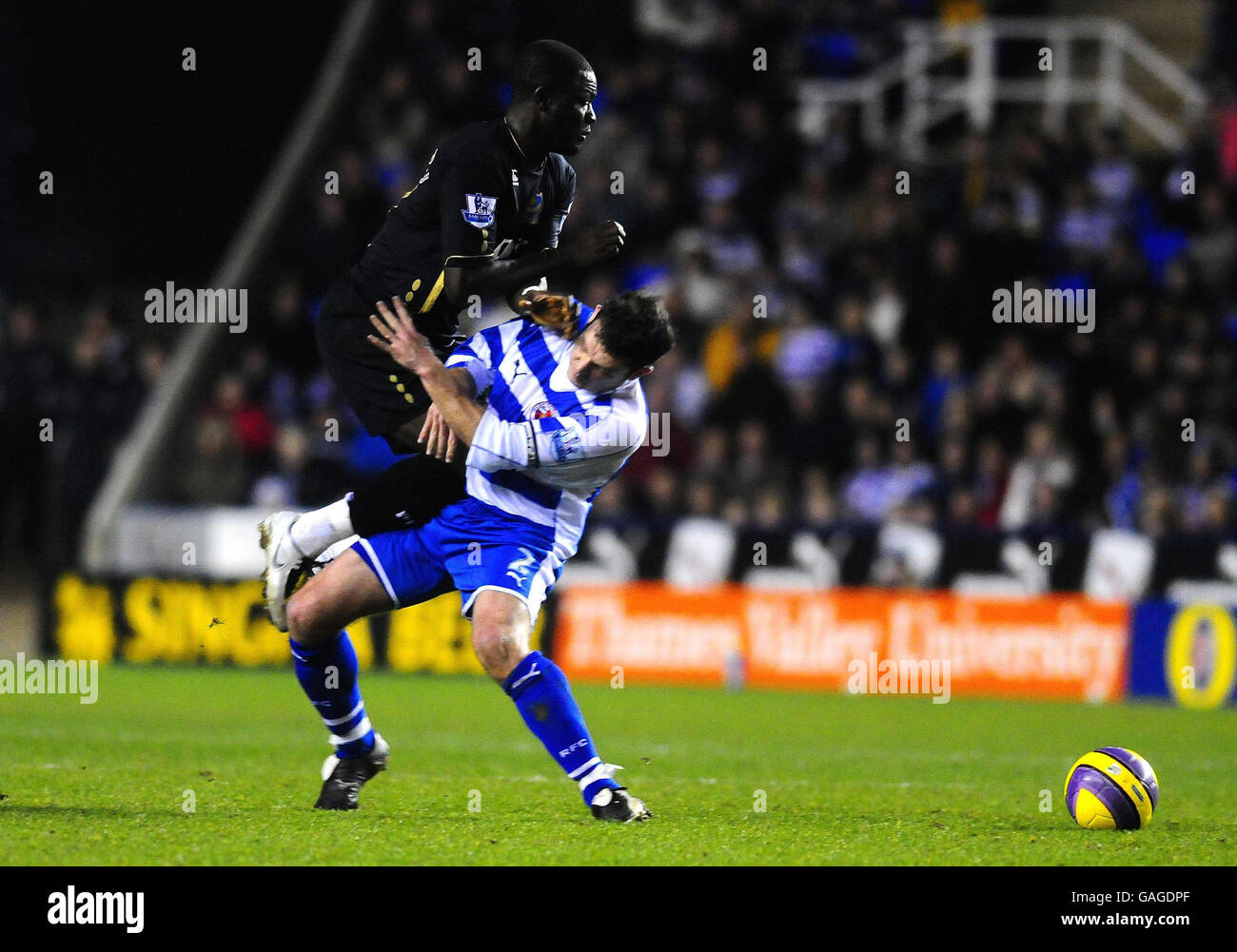 Portsmouth's Sulley Muntari (left) and Reading's Graeme Murty in action during the Barclays Premier League match at the Madejski Stadium, Reading. Stock Photo