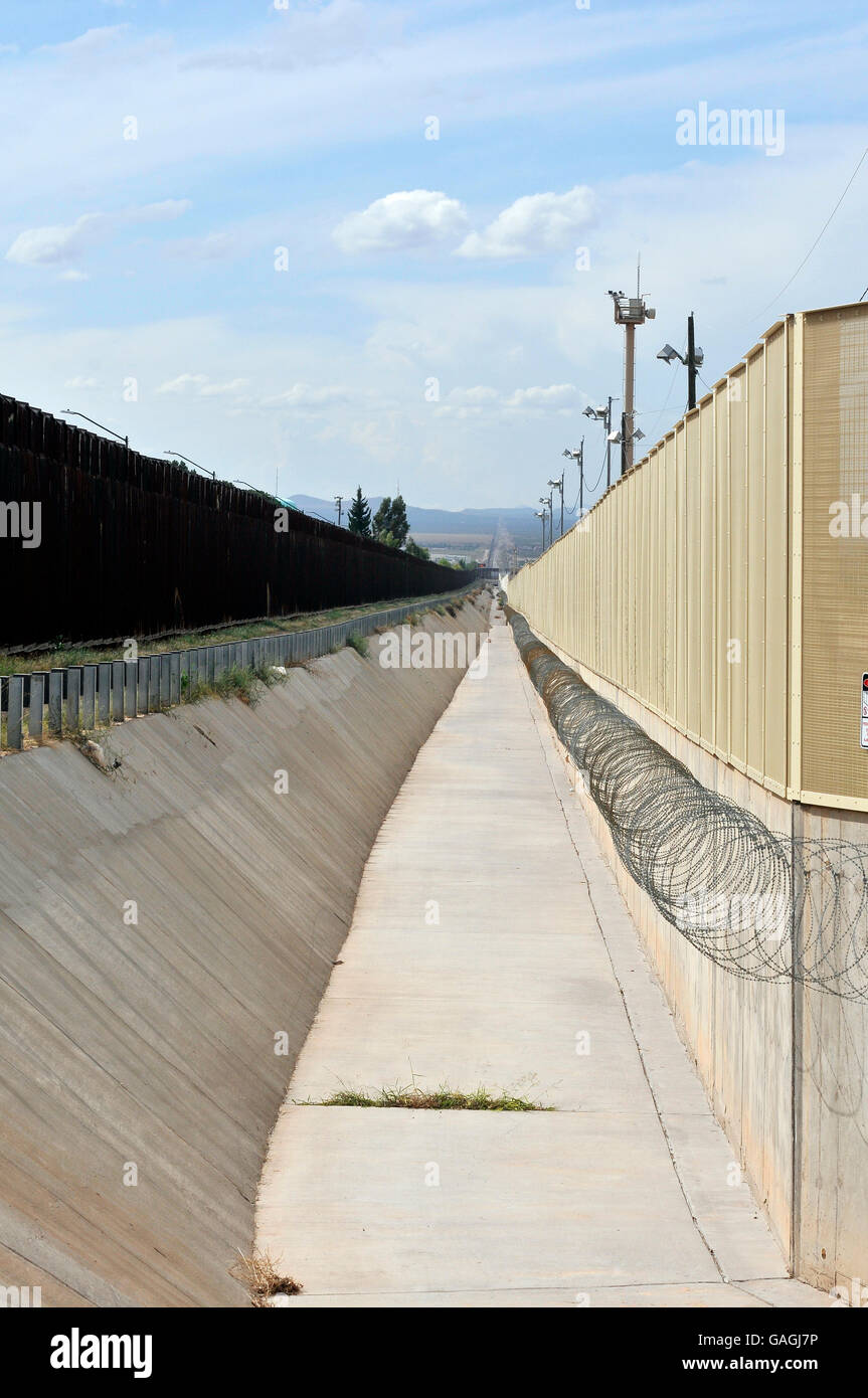A culvert runs along the international border wall between Agua Prieta, Sonora, Mexico, and Douglas Arizona, USA, as seen from A Stock Photo
