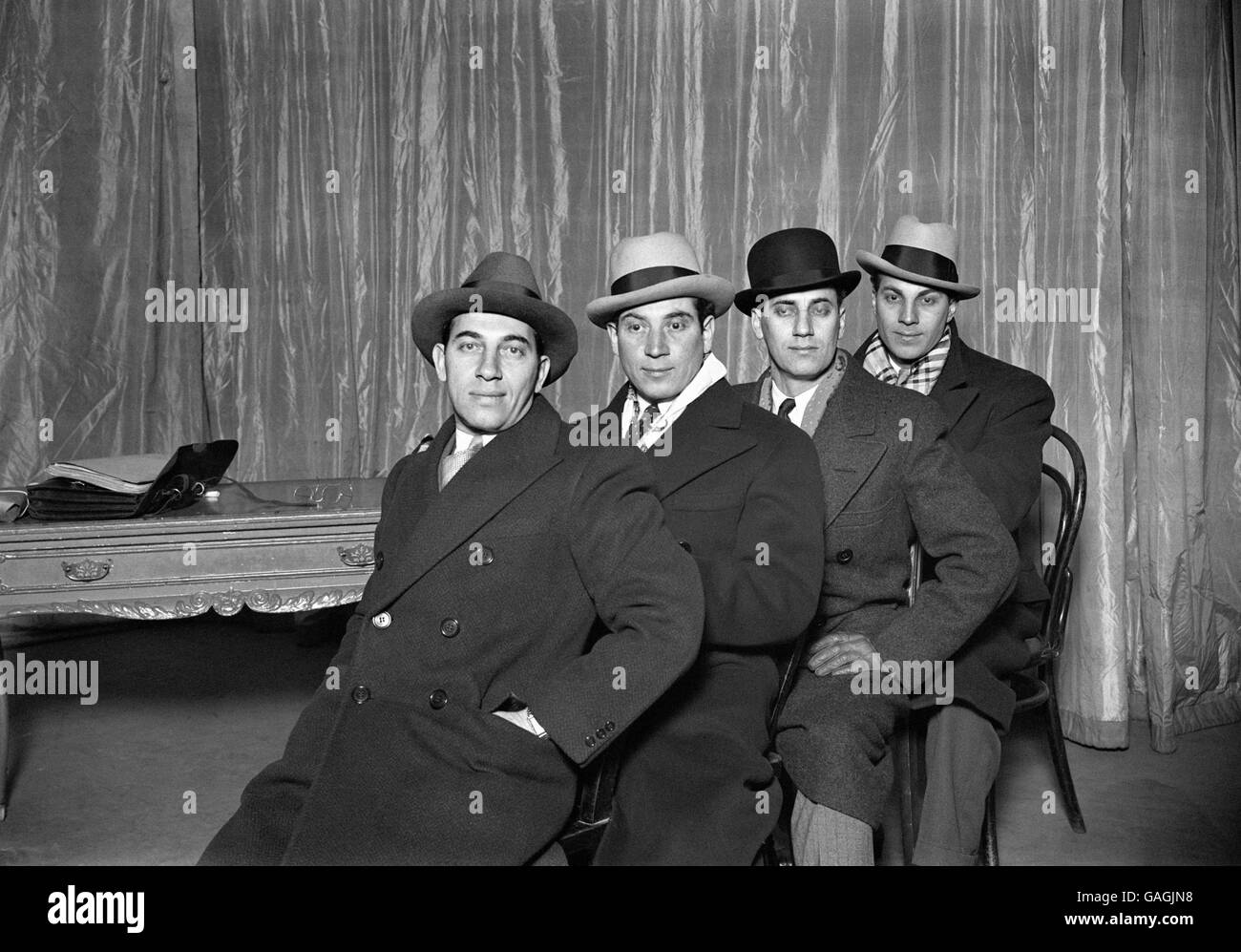The four American Marx brothers arrive in London, from left Chico, Harpo, Groucho and Zeppo. Stock Photo