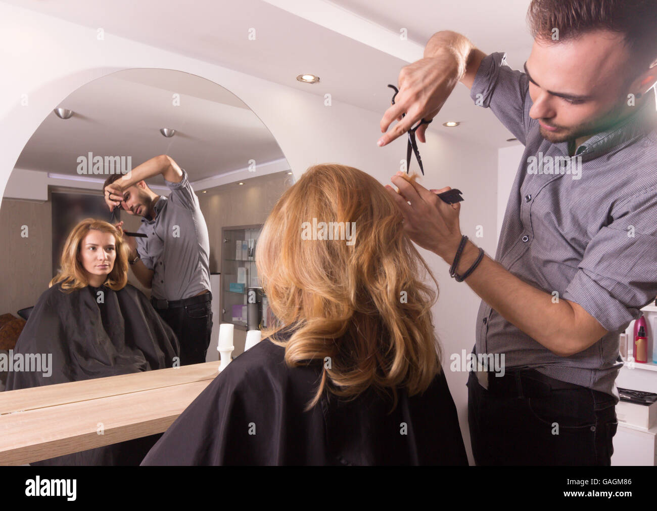 hairdresser salon mirror point cutting hair scissors comb Stock Photo