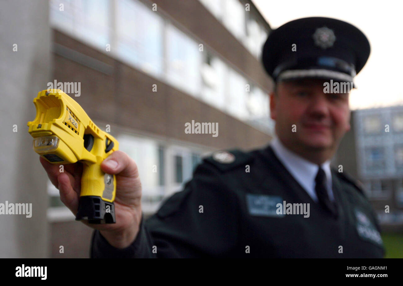 Police Service of Northern Ireland Assistant Chief Constable Roy Toner holding a Taser stun gun outside the PSNI Headquarters in Belfast. Stock Photo