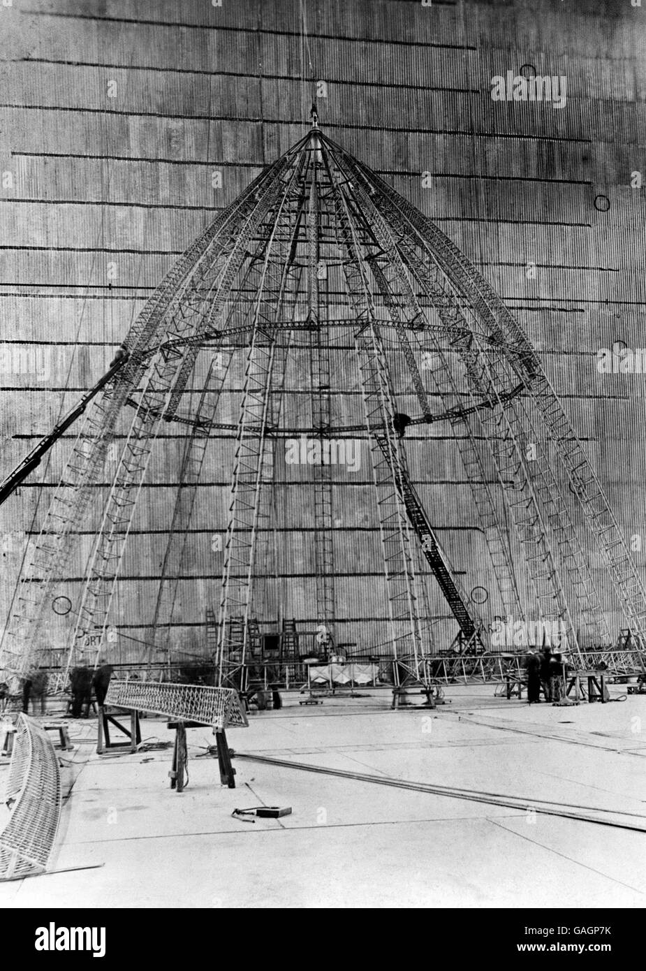 The nose piece of the R101 under construction at the Royal Airship Works at Cardington in Bedfordshire. The R101 Airship was a British airship that crashed on October 5, 1930, in France, during its maiden overseas voyage, killing 48 people. Amongst airship accidents of the 1930s, the loss of life surpassed the Hindenburg disaster of 1937, and was second only to that of the USS Akron crash of 1933. The demise of the R101 effectively ended British employment of rigid airships. Stock Photo