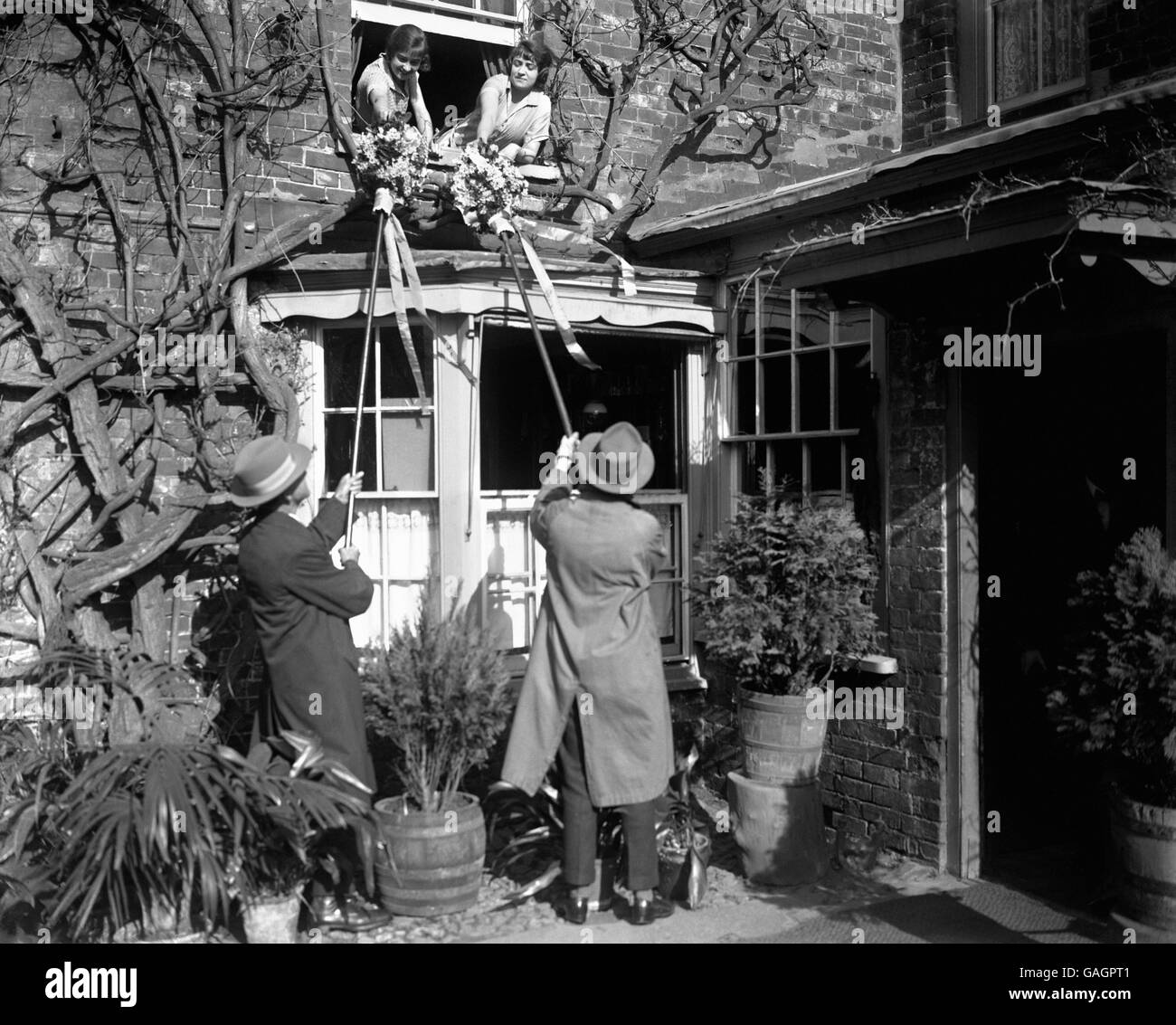 'Tuttimen' offering oranges to willing recipients during Hock Tuesday at Hungerford. Stock Photo