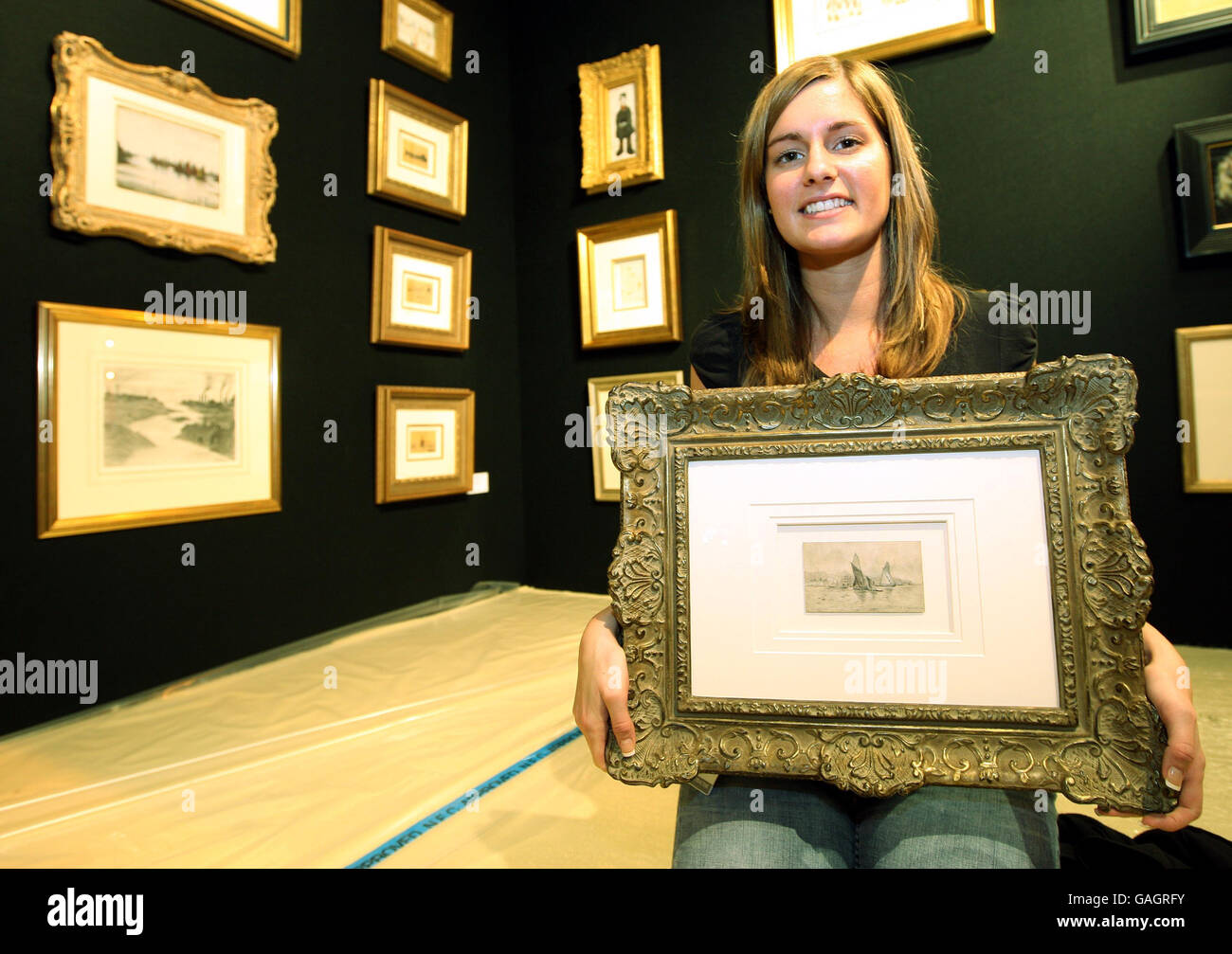 Fine art representative Lauren Moore shows the earliest known work by LS Lowry which is to be sold at the Fine Art and Antiques Fair at the NEC, Birmingham this weekend, 16th - 20th January 2008. Stock Photo