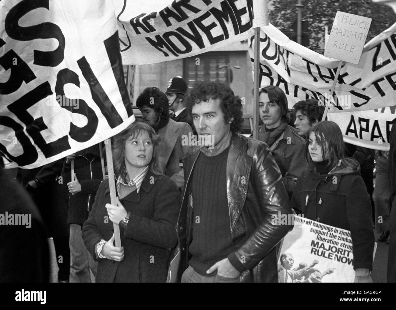 Young Liberals leader Peter Hain among Anti-Apartheid movement demonstrators who marched from Charing Cross Embankment to a rally in Trafalgar Square, to protest the 10th Anniversary of the declaration of UDI by the Smith regime in Rhodesia. Stock Photo