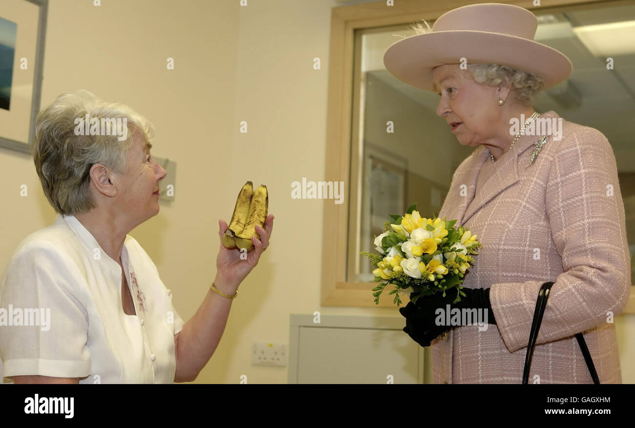 Britain's Queen Elizabeth II is presented with a bunch of bananas by a