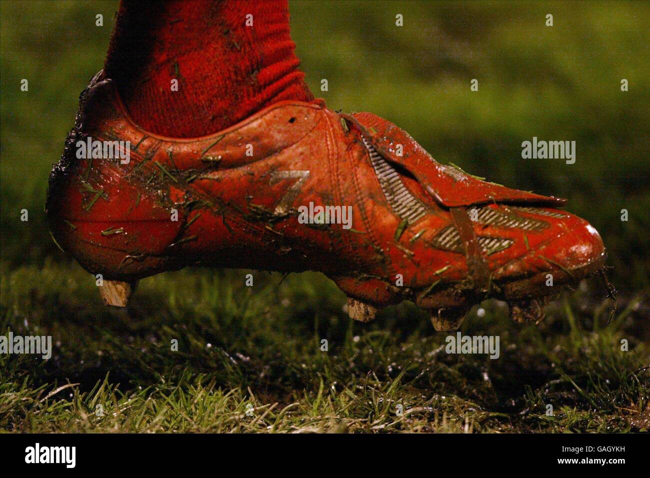 David Beckhams boots are covered in mud after 90 minutes of play in the muddy conditions during the European Championships 2004 Qualifier Match. Stock Photo