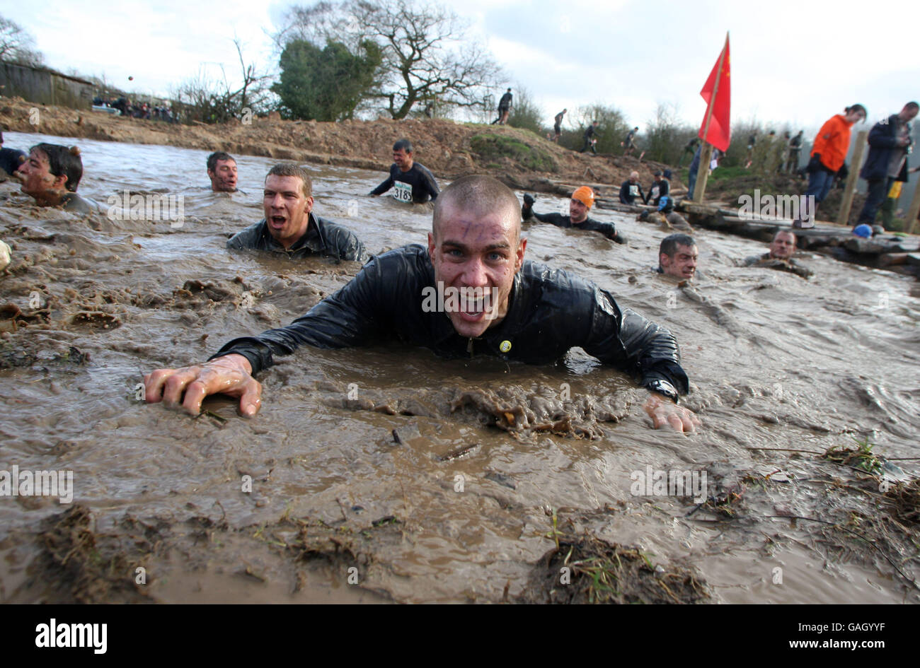 Tough Guy 2008 - Perton, Wolverhampton. Comtetitors emerge from the water during one of the obstacles in the Tough Guy 2008 race Stock Photo