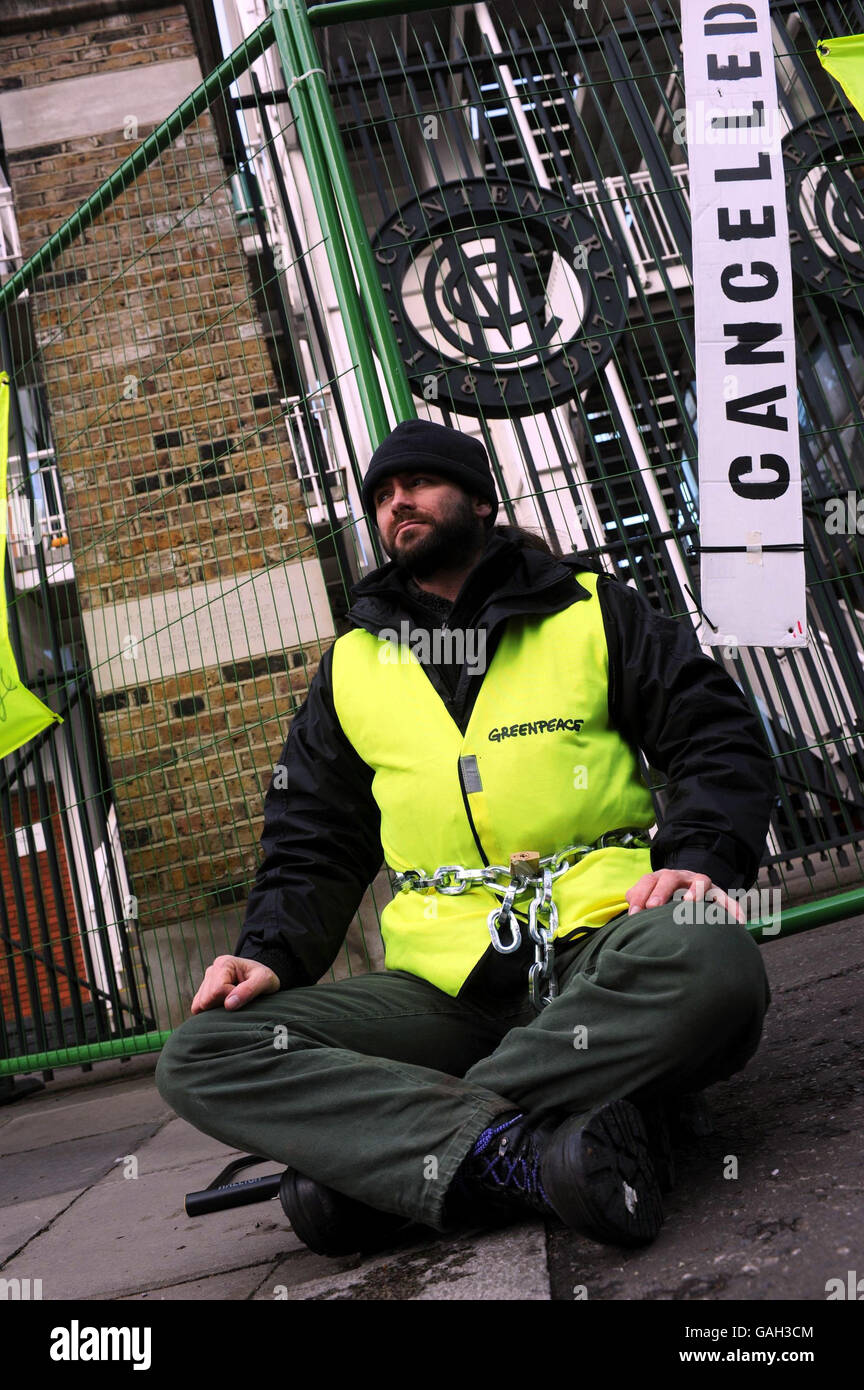 An environmental protester is chained outside the Grace Gates at Lord's cricket ground in central London for a demonstration against carbon emissions. The cricket ground is the venue for the Coal UK Conference 2008. Stock Photo